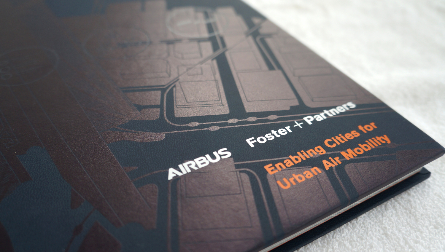 Bespoke book for Airbus - Enabling Cities for Urban Air Mobility. Detail of front cover and spot varnish